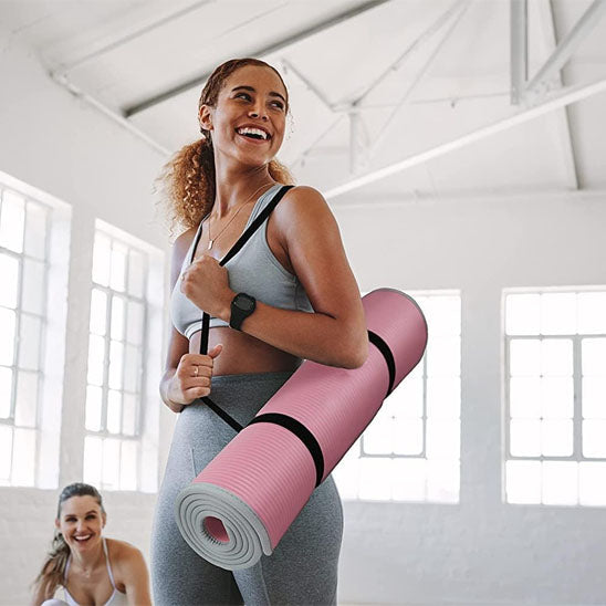 Femme avec un tapis rouler sur l’ épaule 